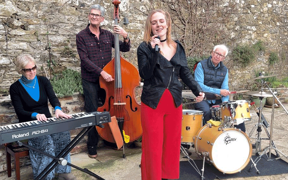 Picture of Corinne and the band in a garden
